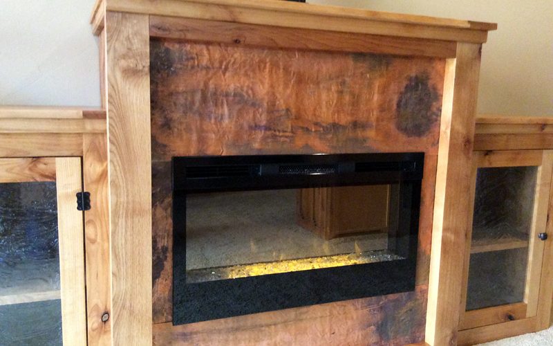 custom furniture // copper accents // handmade fireplace cabinet by Mike Dumas Copper Designs.
